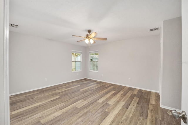 spare room with ceiling fan and wood-type flooring