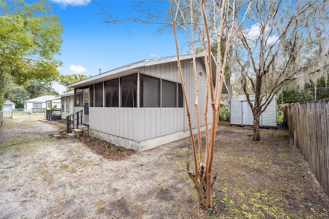 view of side of property featuring a shed