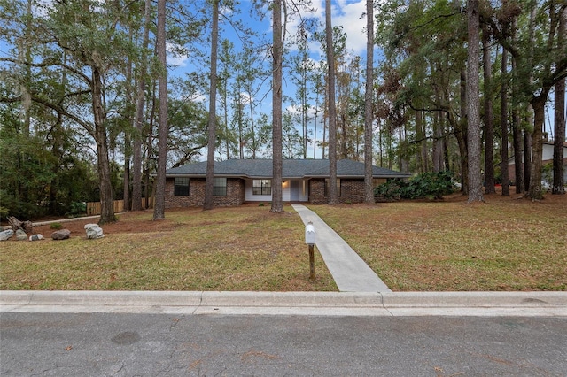 single story home featuring a front lawn