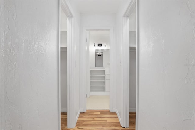 corridor with light hardwood / wood-style floors