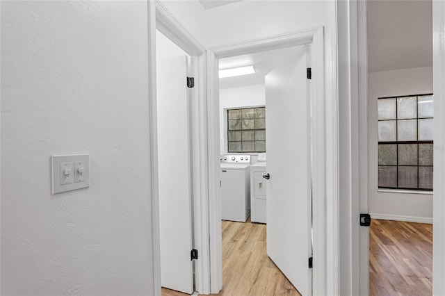 hallway featuring washer and dryer and light hardwood / wood-style flooring