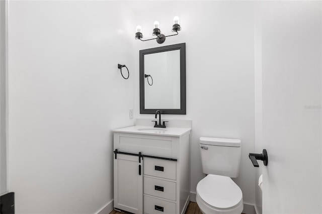 bathroom with toilet and vanity