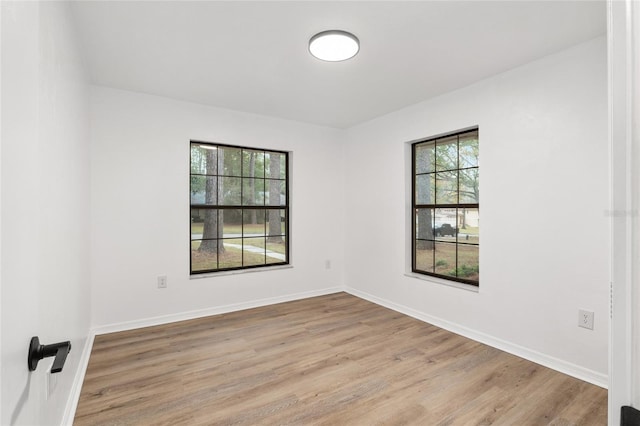 unfurnished room with light wood-type flooring