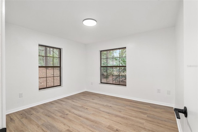 unfurnished room with light hardwood / wood-style floors and plenty of natural light