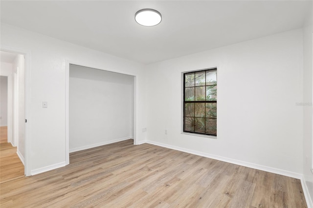 unfurnished bedroom featuring a closet and light hardwood / wood-style flooring