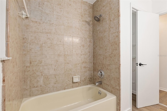 bathroom featuring tiled shower / bath combo and hardwood / wood-style floors