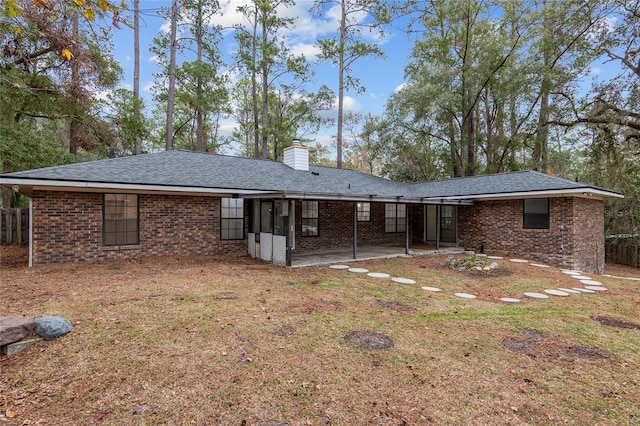 back of house featuring a patio and a yard