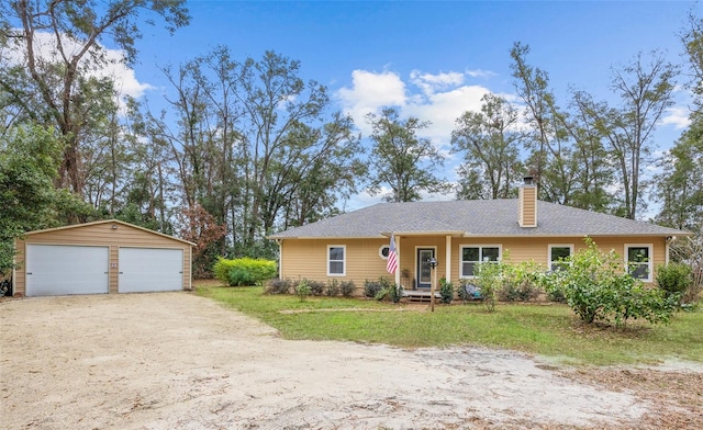 single story home with a garage and an outdoor structure