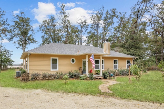 ranch-style home with central AC and a front lawn