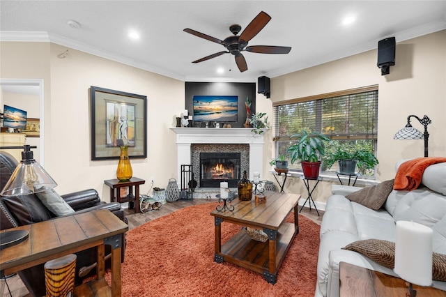 living room with hardwood / wood-style flooring, ceiling fan, and crown molding