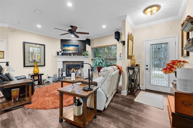 living room featuring ceiling fan, dark wood-type flooring, and crown molding