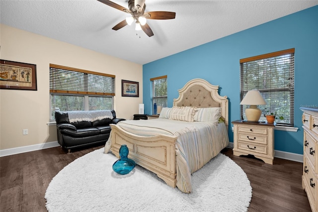 bedroom with multiple windows, ceiling fan, a textured ceiling, and dark hardwood / wood-style floors