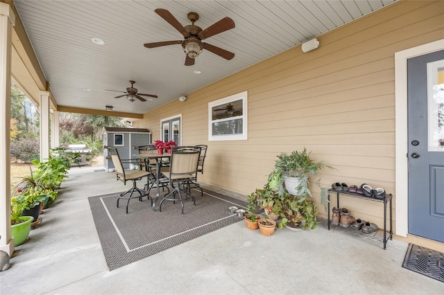 view of patio with ceiling fan and a storage shed