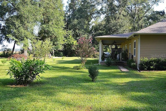 view of yard with ceiling fan