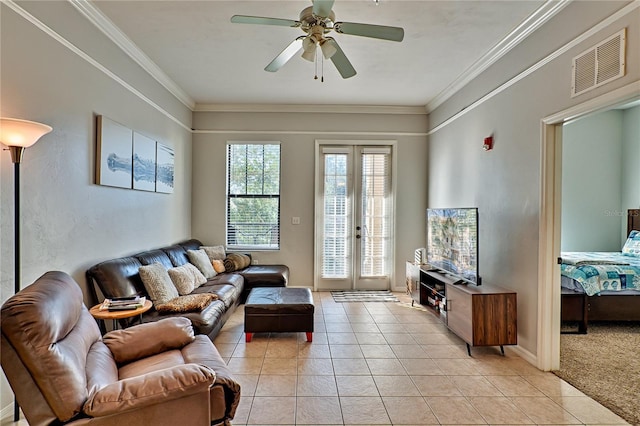 tiled living room featuring ceiling fan, french doors, and ornamental molding