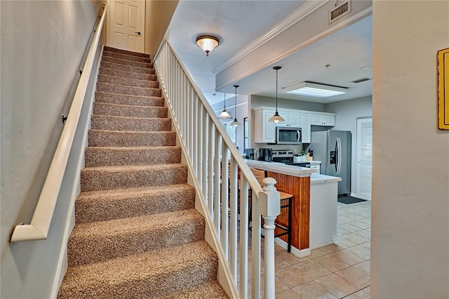 staircase featuring crown molding