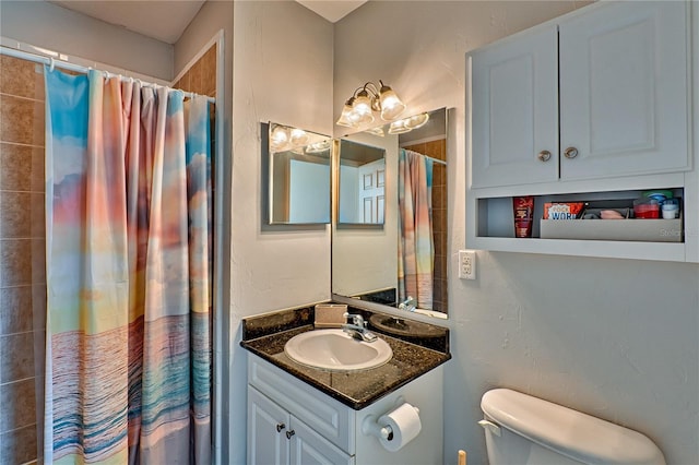 bathroom with toilet, curtained shower, and vanity