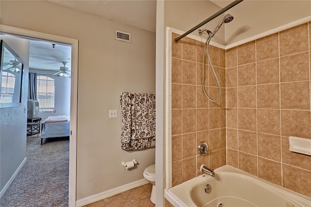 bathroom with ceiling fan, tile patterned flooring, toilet, and tiled shower / bath