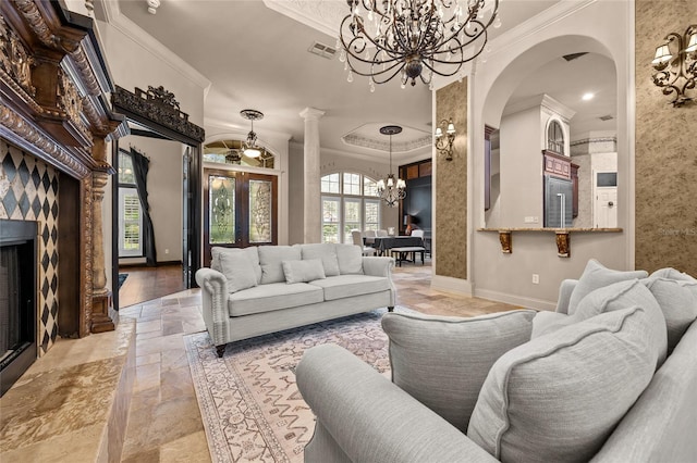 living room with ornamental molding, a high end fireplace, and decorative columns