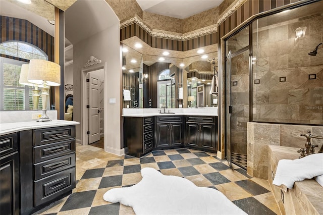 bathroom with tiled shower and vanity