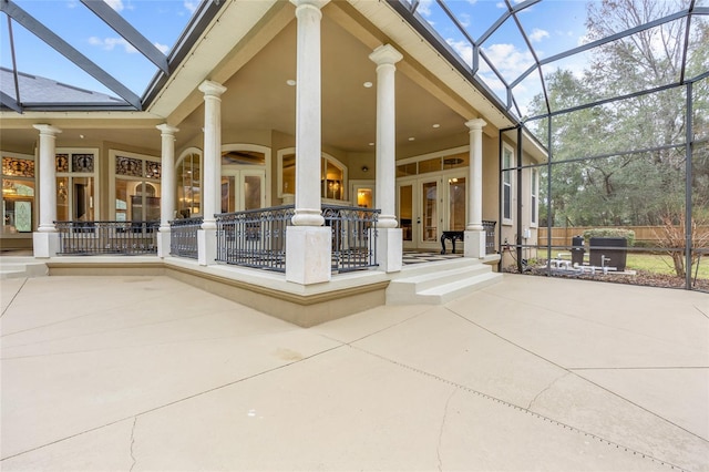 view of patio with french doors and glass enclosure