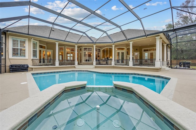 view of pool featuring a patio, french doors, and glass enclosure