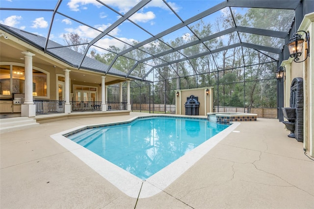 view of pool featuring a lanai, a patio area, and an in ground hot tub