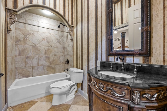 full bathroom with toilet, tiled shower / bath, and vanity