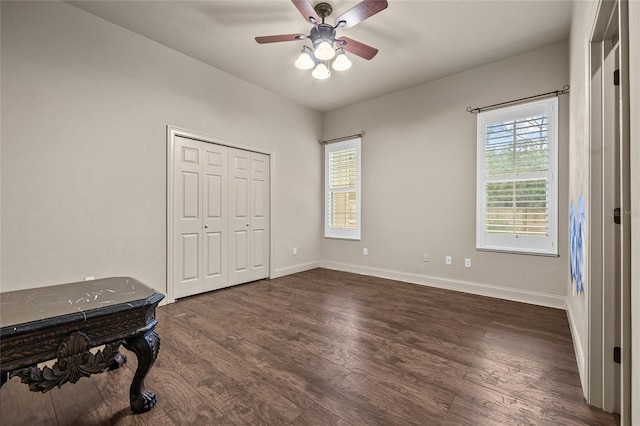 bedroom with dark hardwood / wood-style flooring, multiple windows, a closet, and ceiling fan