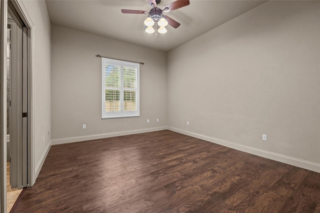 unfurnished bedroom with ceiling fan and dark wood-type flooring