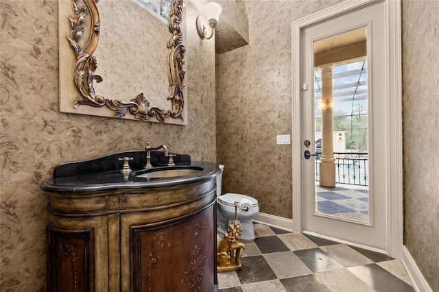 bathroom featuring toilet and vanity