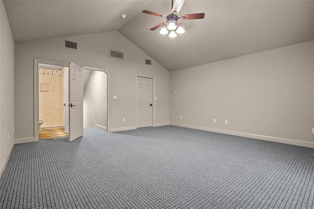 unfurnished bedroom featuring vaulted ceiling, connected bathroom, ceiling fan, and carpet