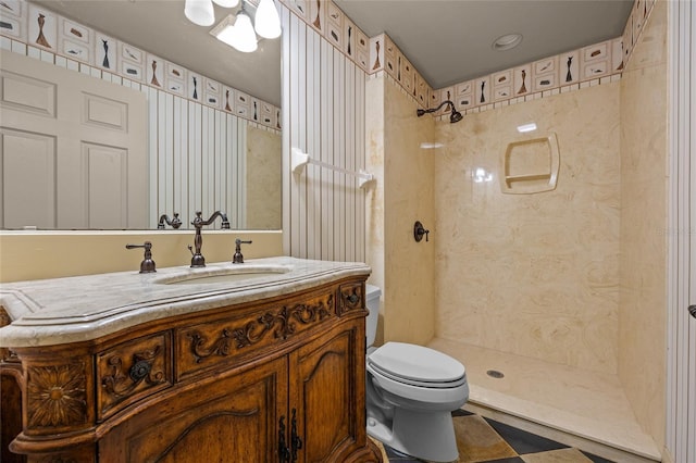 bathroom with tile patterned floors, a shower, vanity, and toilet