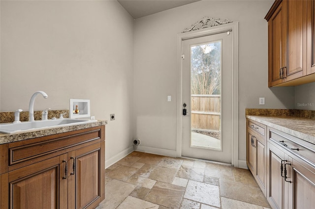 washroom with sink, electric dryer hookup, hookup for a washing machine, and cabinets