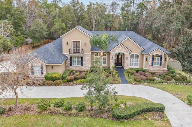 view of front facade featuring french doors and a front lawn