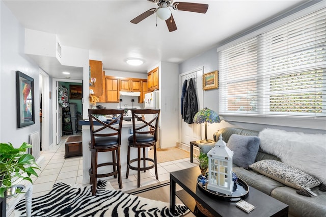 tiled living room featuring ceiling fan