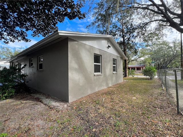 view of property exterior with a yard