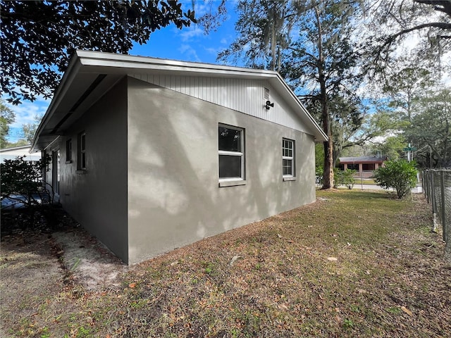 view of side of home with a lawn