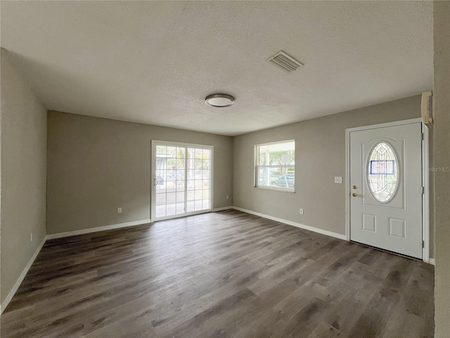 entryway featuring a textured ceiling and dark hardwood / wood-style flooring