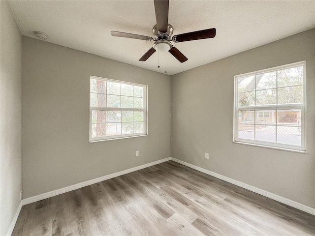 empty room with light hardwood / wood-style floors and ceiling fan