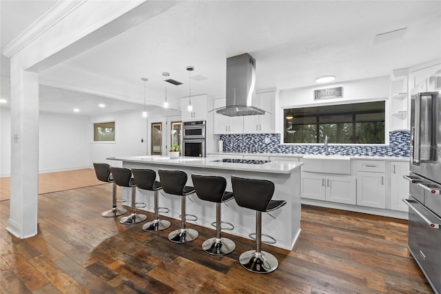 kitchen featuring white cabinetry, island range hood, a kitchen island, pendant lighting, and stainless steel appliances