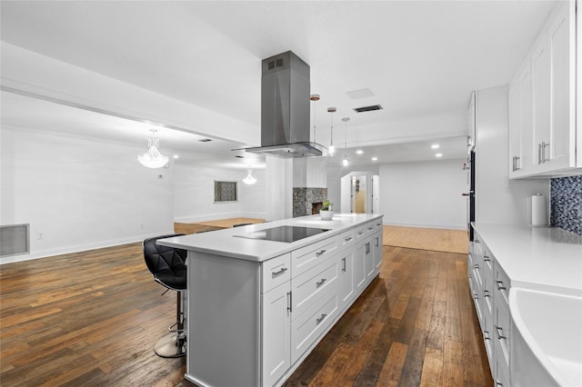 kitchen featuring white cabinetry, a center island, island exhaust hood, and black electric stovetop