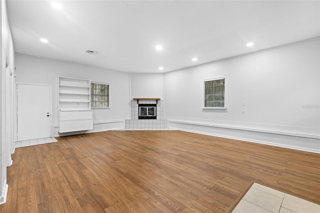 unfurnished living room with a fireplace and light hardwood / wood-style flooring