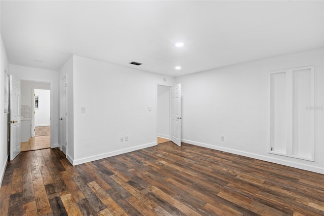 empty room with dark wood-type flooring