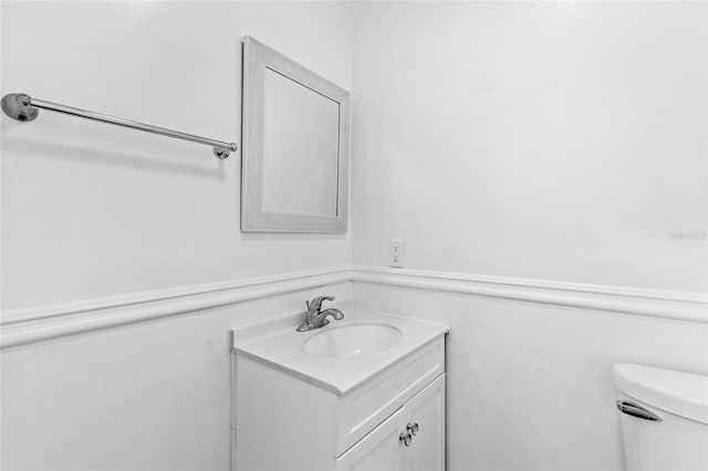 bathroom featuring vanity and toilet