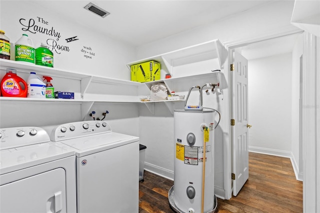 washroom featuring water heater, washing machine and clothes dryer, and dark hardwood / wood-style flooring