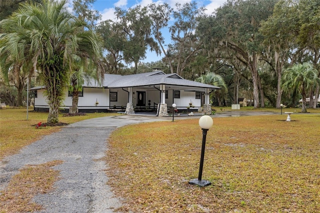 view of front of property with a front yard and a porch