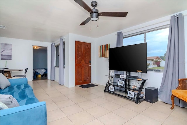 living room with ceiling fan and light tile patterned floors