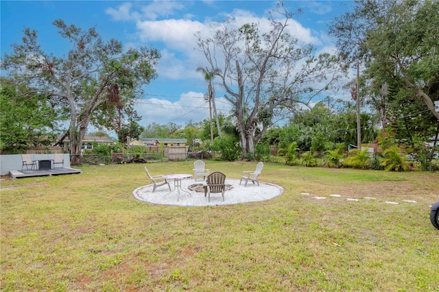 view of yard featuring an outdoor fire pit and a deck