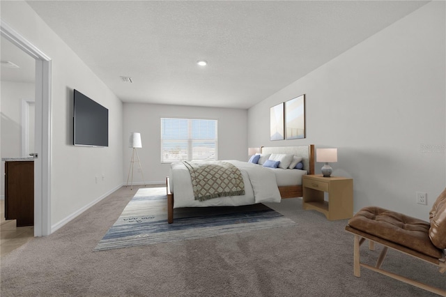 bedroom featuring light carpet and a textured ceiling